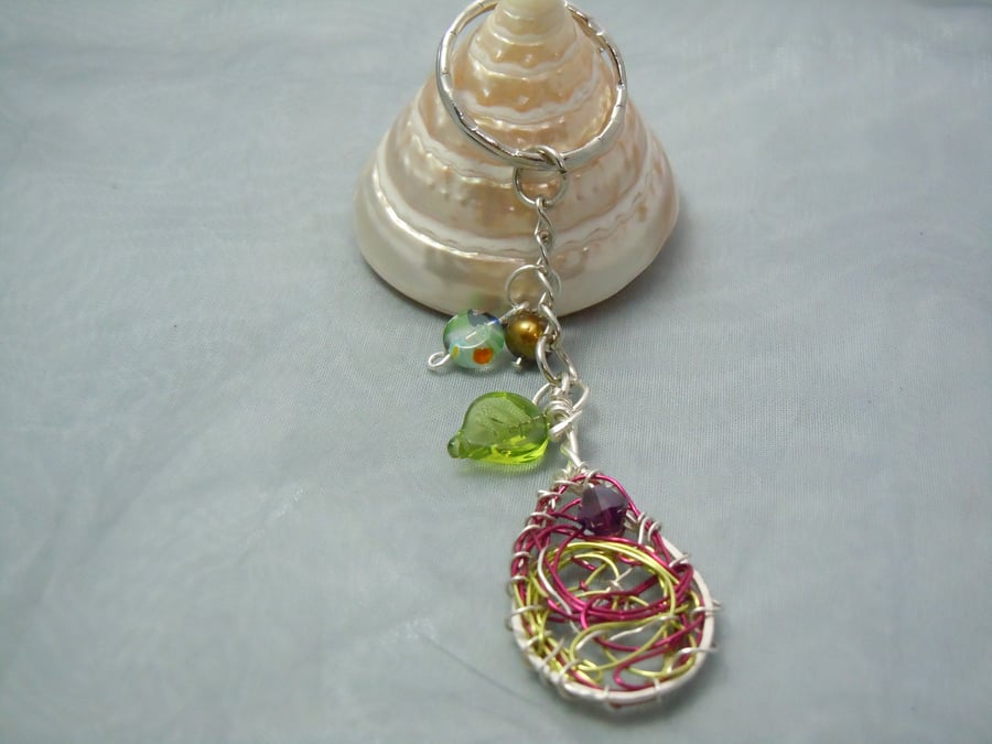 Keyring & bag charm in silver tone metal with wirework oval charm