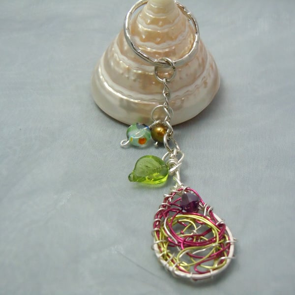 Keyring & bag charm in silver tone metal with wirework oval charm