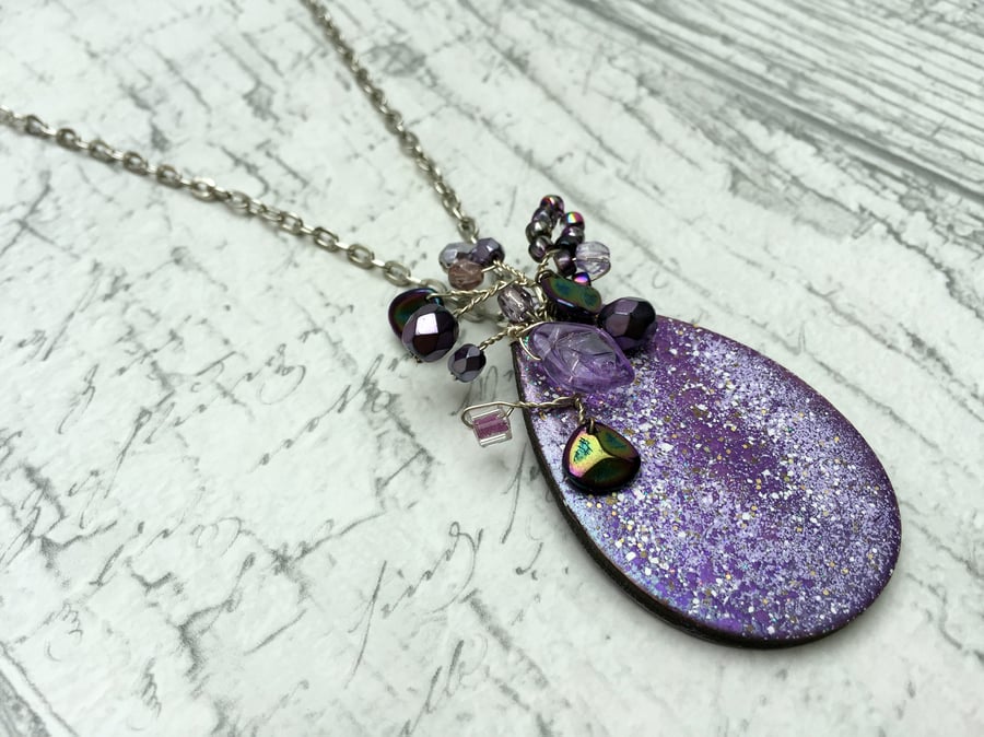 Purple wooden teardrop pendant with Bead wire wrapped centrepiece