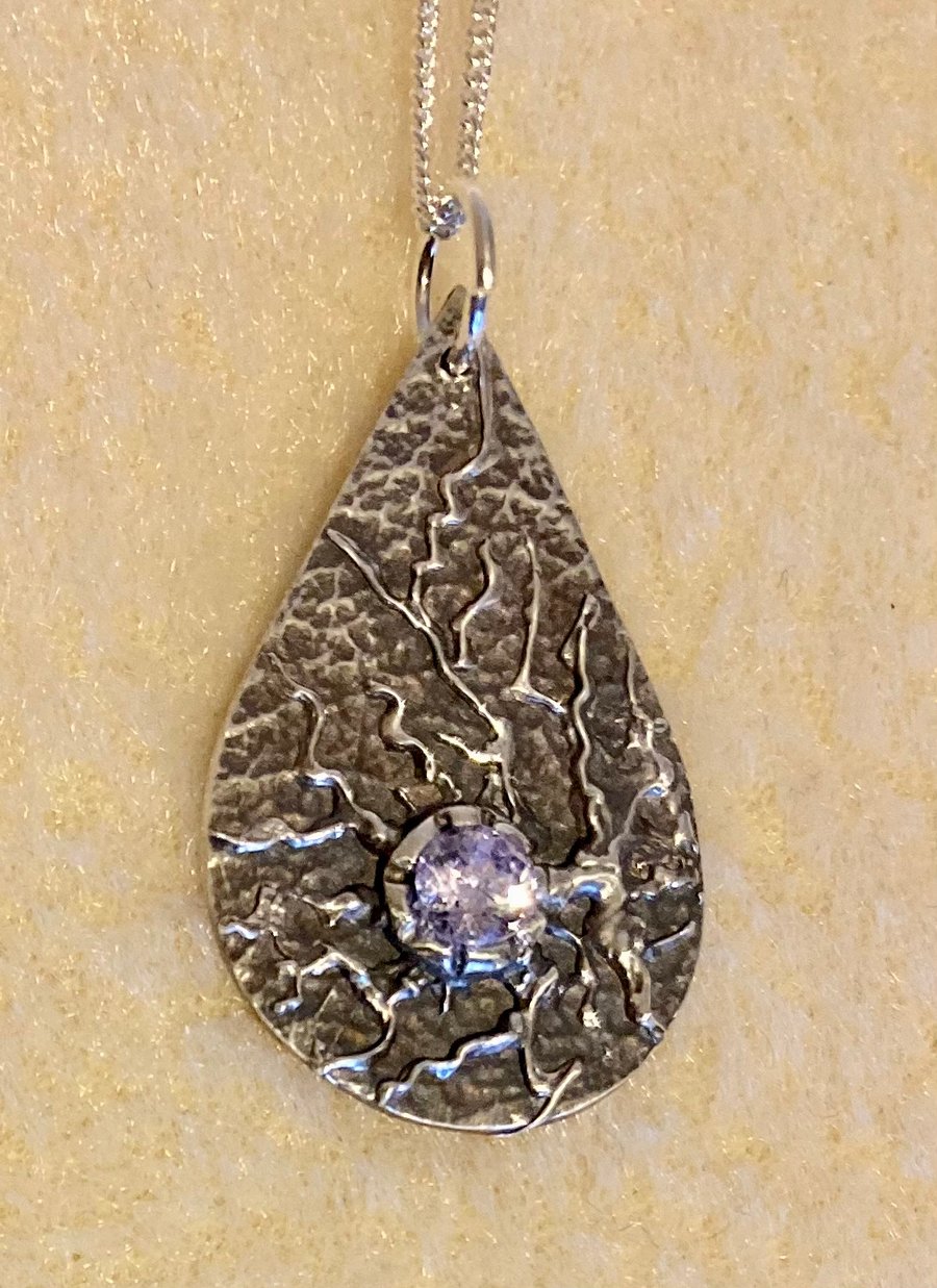 Silver teardrop with crystal and organic textures