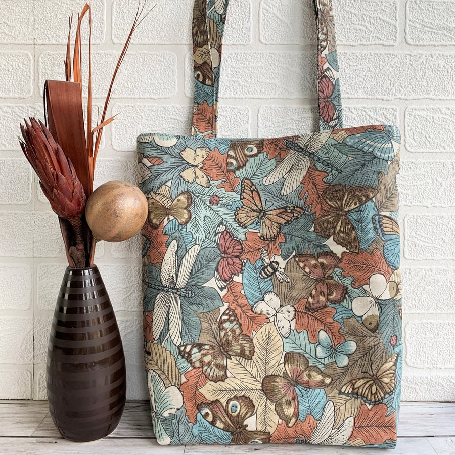 Wildlife tote bag with butterflies and other insects on leaves