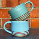 Hand made blue & green pottery mugs with tape resist detail. 