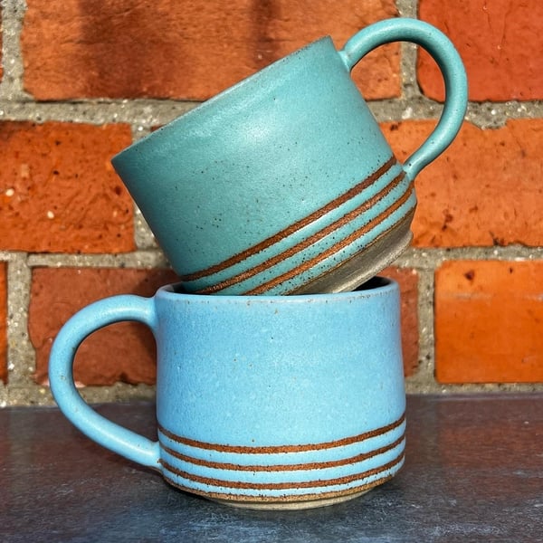Hand made blue & green pottery mugs with tape resist detail. 