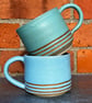 Hand made blue & green pottery mugs with tape resist detail. 