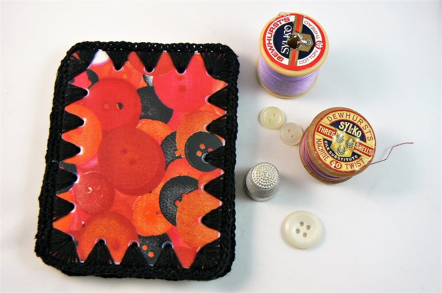 Needle case (button print with black crochet edging) and wipe clean cover.