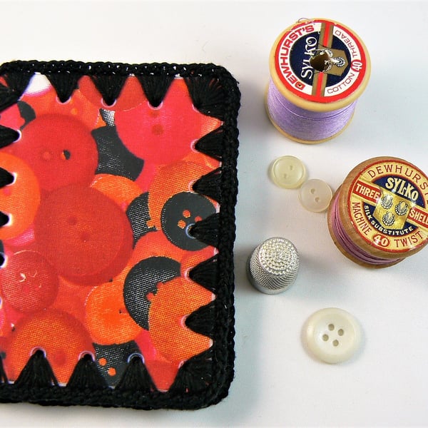 Needle case (button print with black crochet edging) and wipe clean cover.