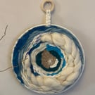 Blue and white circular wall hanging 