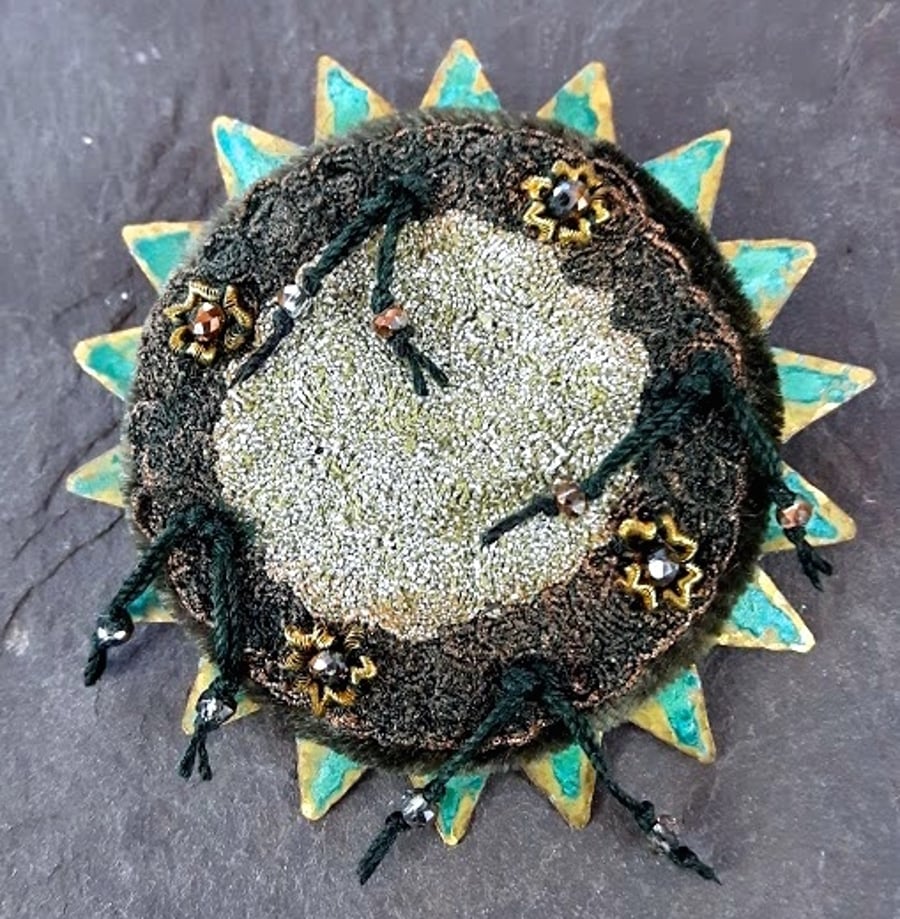 Brooch embroidery embellished verdigris patinated brass star.