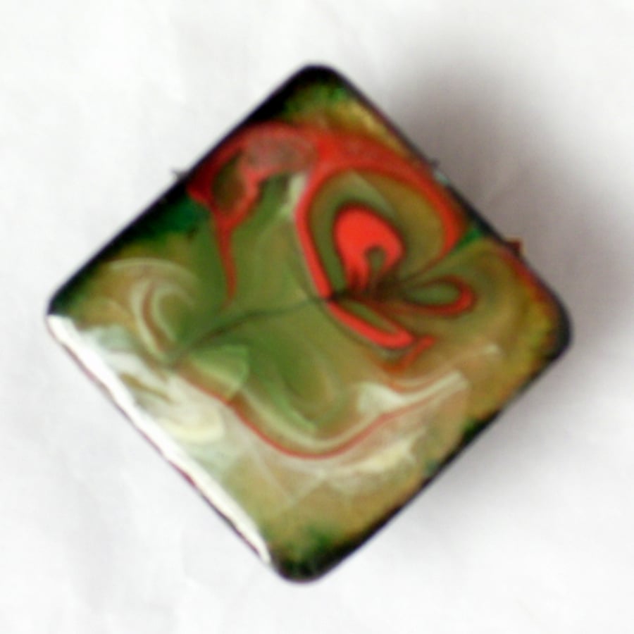 square brooch - scrolled red and white on green over clear enamel
