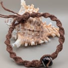 Handmade macrame bracelet with a lamp work glass bead 