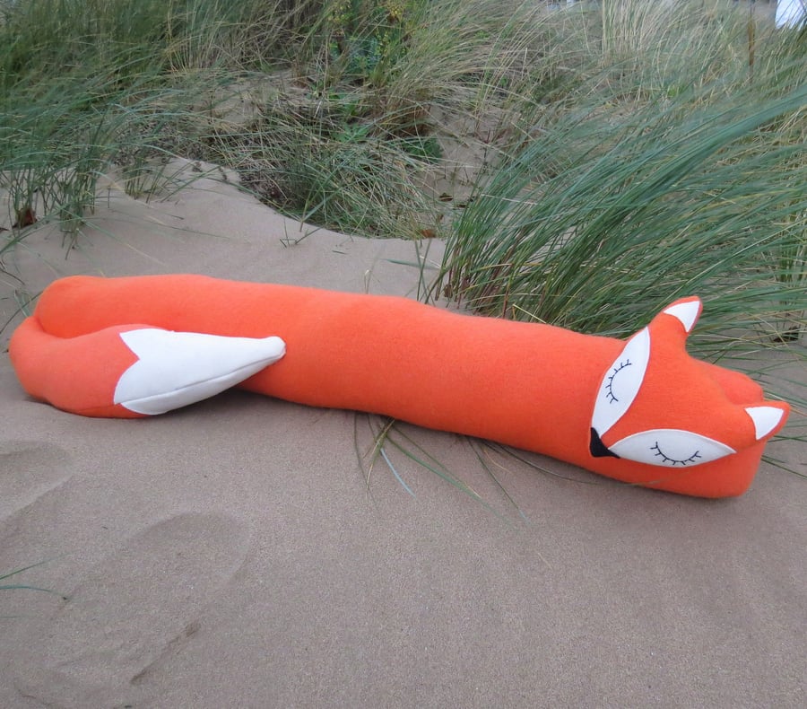 Long fox.  A snoozy fox draught excluder, made from a vibrant orange wool.