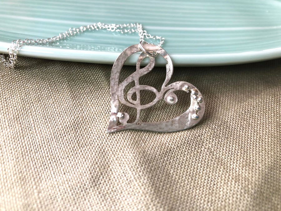 Silver Heart Pendant with Treble Clef Symbol. 