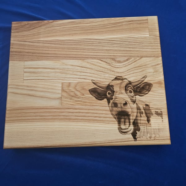 Solid oak chunky chopping board laser engraved crazy cow design.