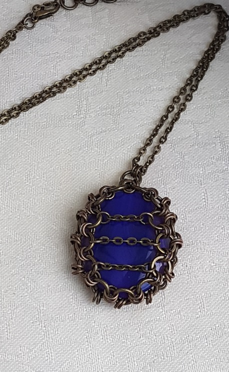 Gorgeous Caged Fire Purple Pendant Necklace.