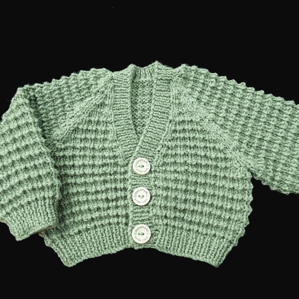 Hand knitted baby cardigan in moss green textured pattern Seconds Sunday