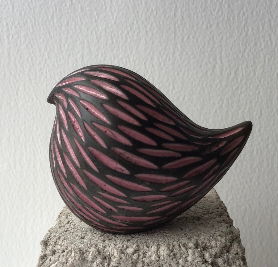 Pink round bird carved