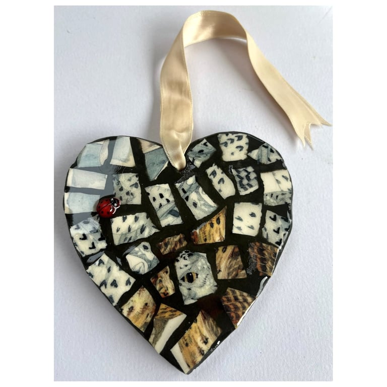 A heart shaped mosaic pendant with a snowy owl theme.