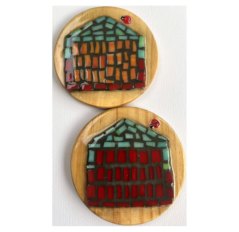 A set of four,resined ceramics 'Beach Hut' themed wooden coasters. 