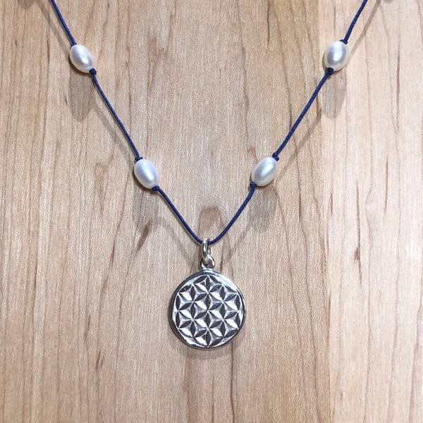 Silver disc pendant strung with freshwater pearls