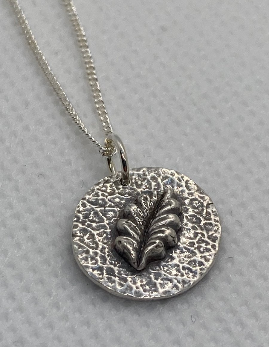 Pure silver necklace with 3D leaf and lovely, textured background. 