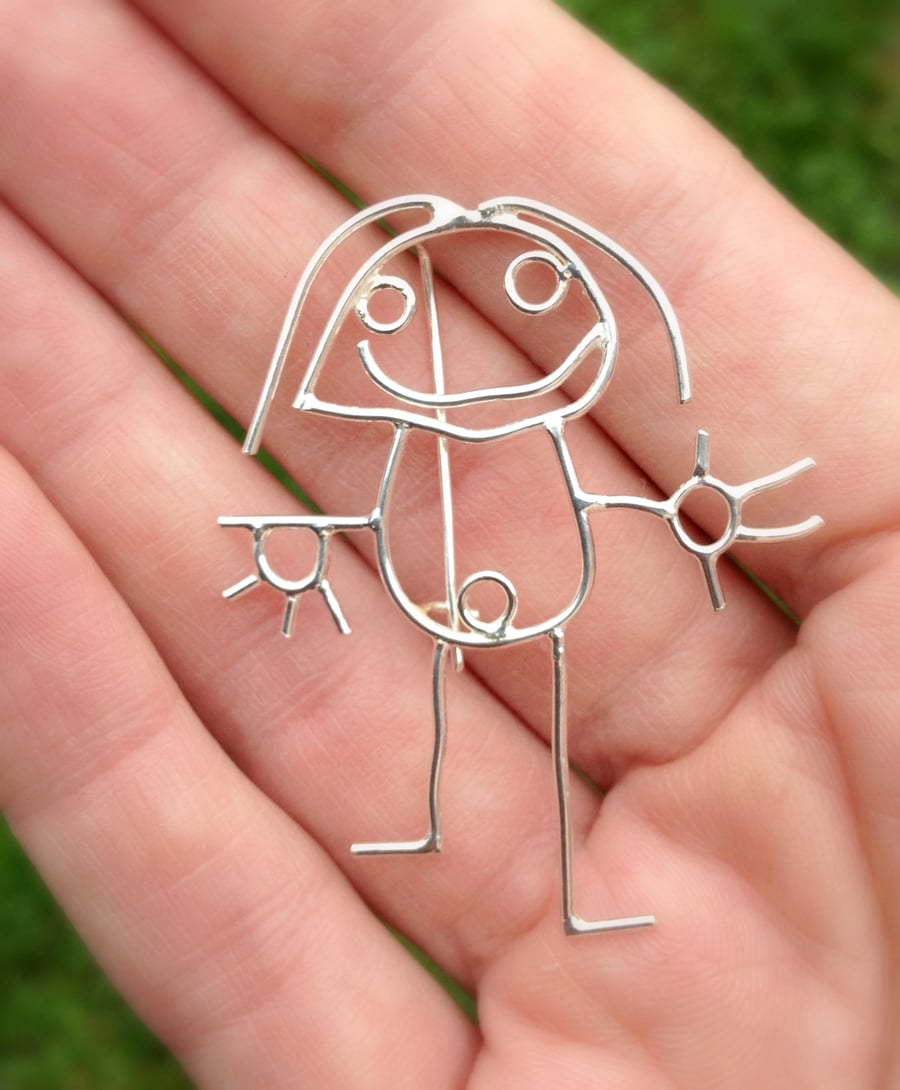 A personalised brooch from a childs drawing made in sterling silver.