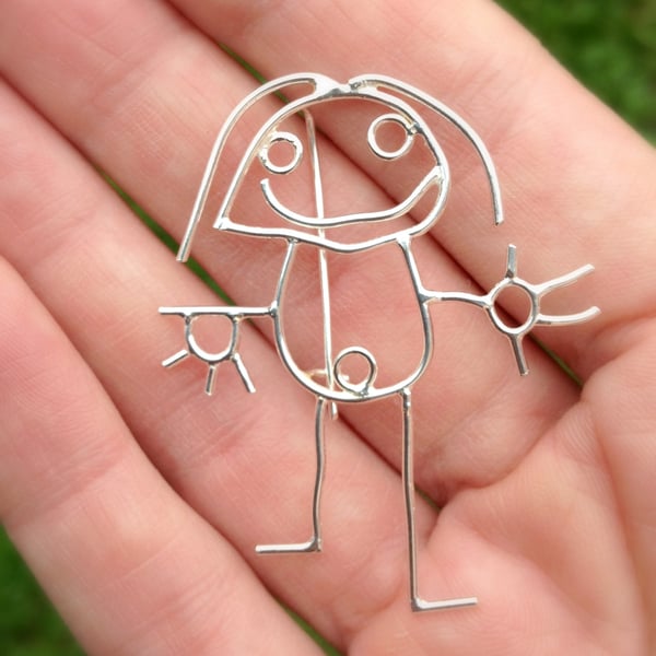 A personalised brooch from a childs drawing made in sterling silver.