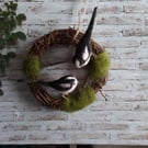 Indoor wreath decoration with needle felted birds .