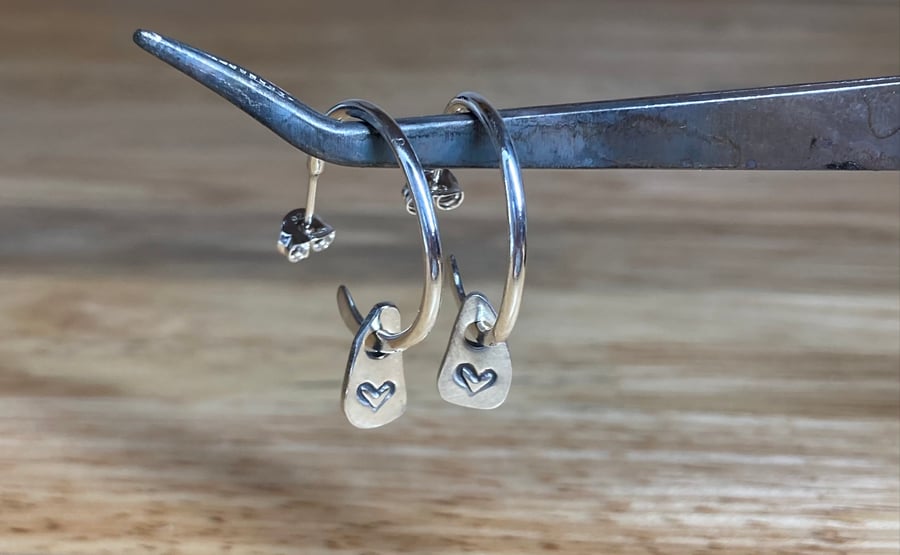 Handmade sterling silver hooped earrings with small dangle heart pebbles