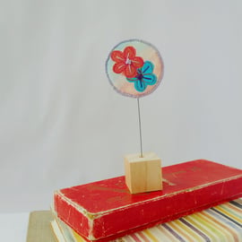 Flower fabric ornament on wooden block