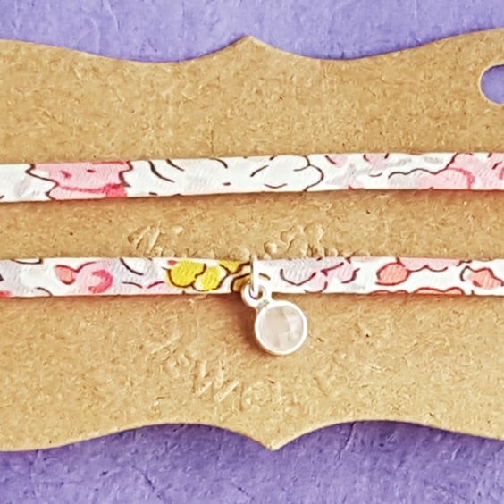 Fabric bracelet with silver charm