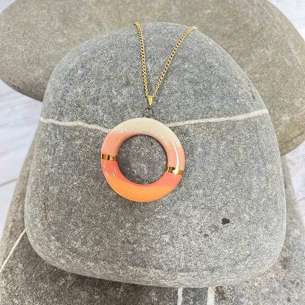 Donut shaped pendant in coral and peach with 24karat Gold detail