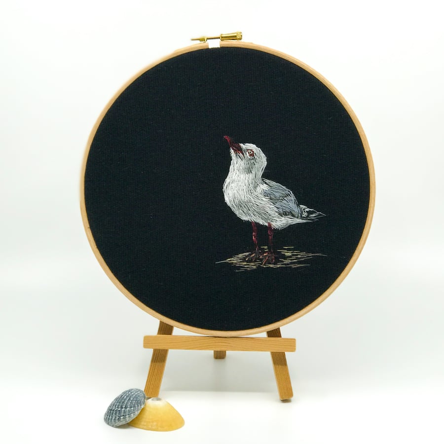 Embroidered hoop picture of a star gazing seagull