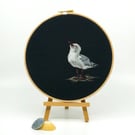 Embroidered hoop picture of a star gazing seagull