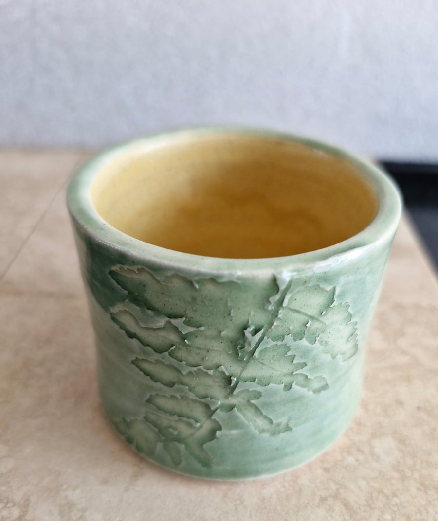 Green and yellow ceramic candle pot