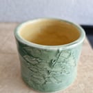 Green and yellow ceramic candle pot