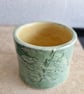 Green and yellow ceramic candle pot