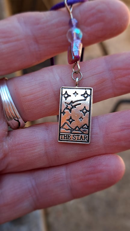 The Star tarot pendant on a purple rope necklace