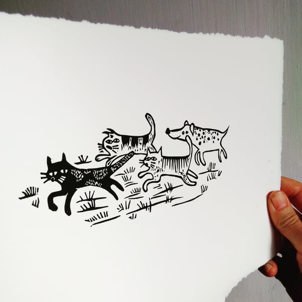 Spotty dog racing three cats - lino print