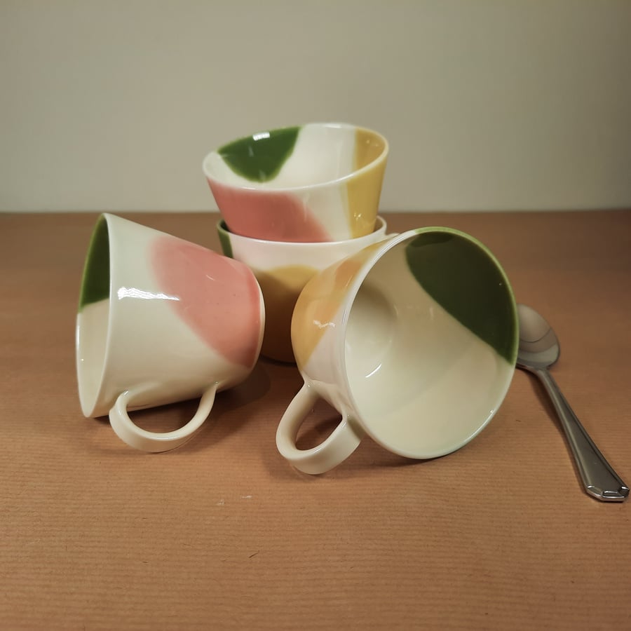 A set of 4 hand made espresso mugs in yellow, pink and green porcelain stoneware