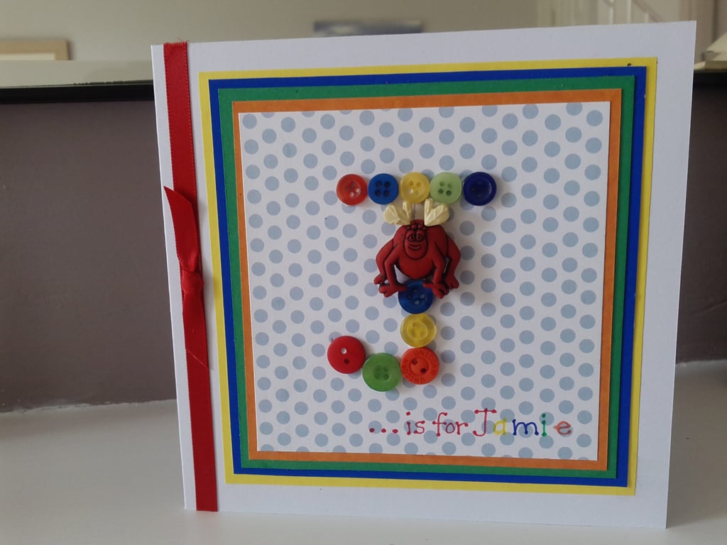 A fun initial button monster birthday card 