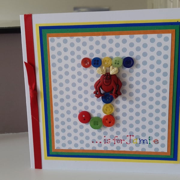 A fun initial button monster birthday card 