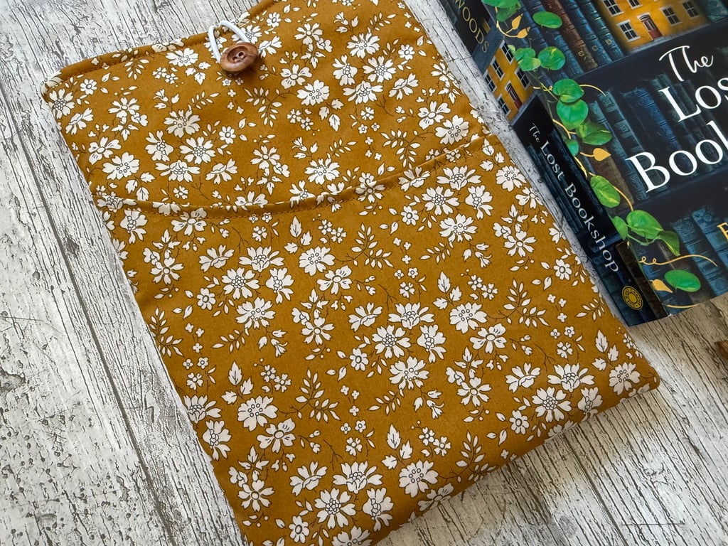 Fabric book sleeve with pocket for paperback books. Padded and fully lined.