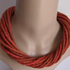 The Twist: felted cord necklace in shades of orange