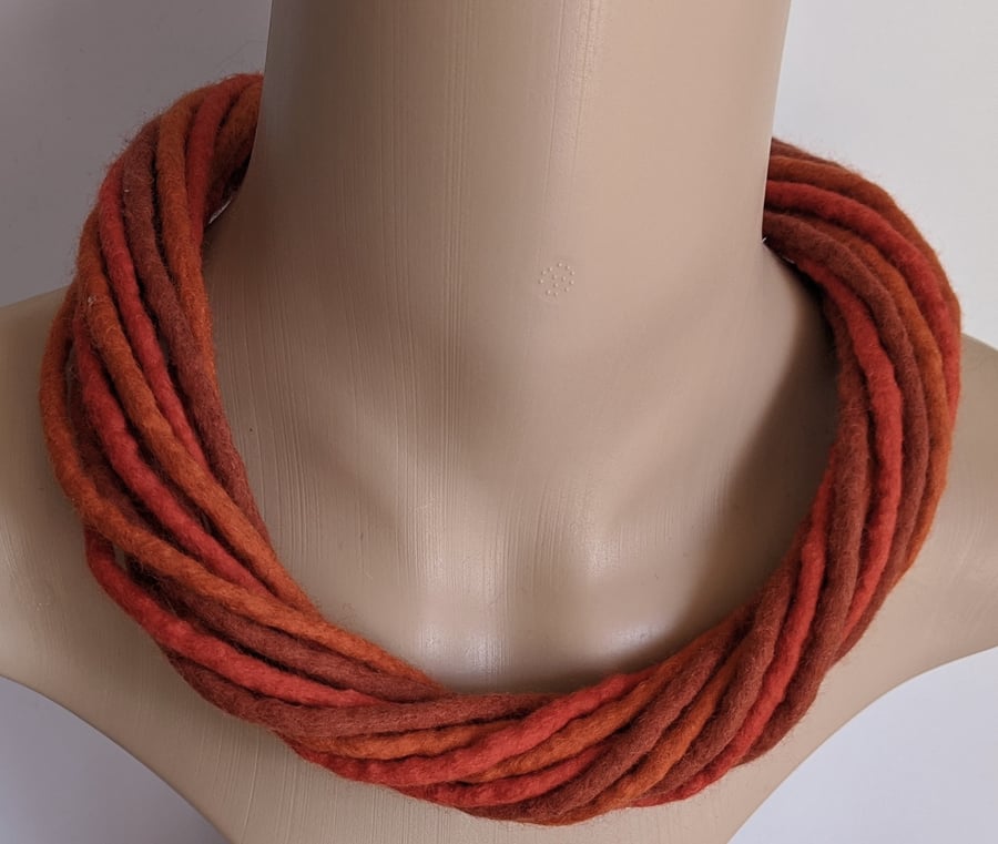 The Twist: felted cord necklace in shades of orange