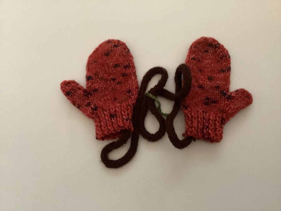 Mittens including attached straps 