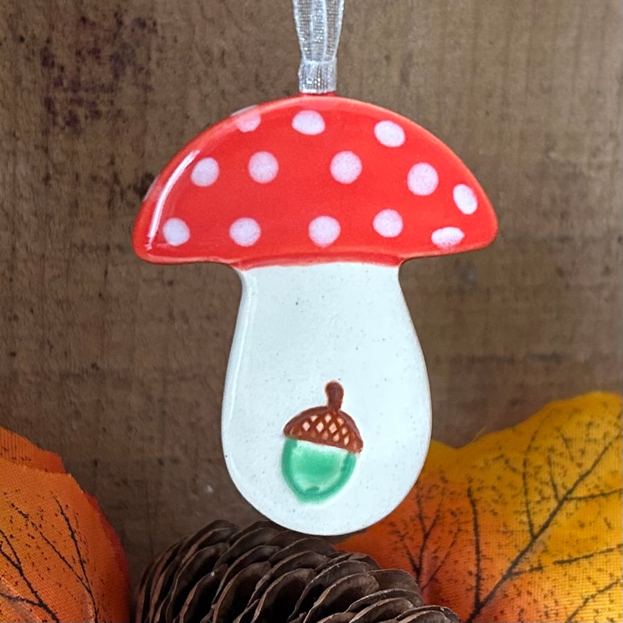 Red ceramic toadstool decoration with acorn detail