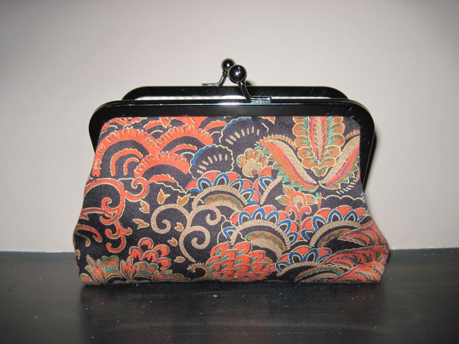 Black, orange, gold fabric bag with 6" antique silver effect frame clasp.