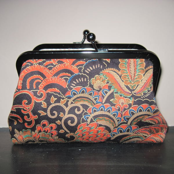 Black, orange, gold fabric bag with 6" antique silver effect frame clasp.
