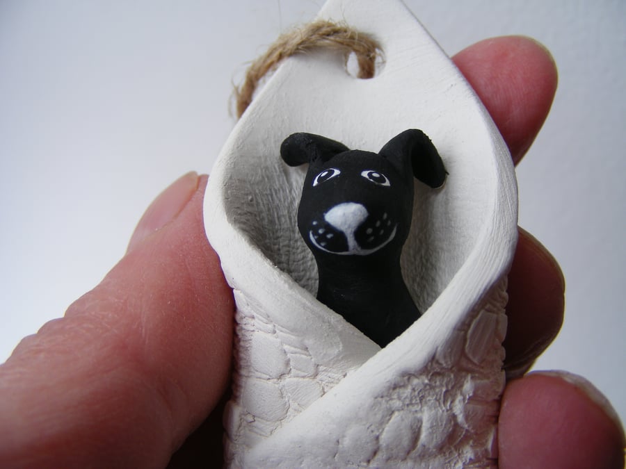 Black dog in a blanket