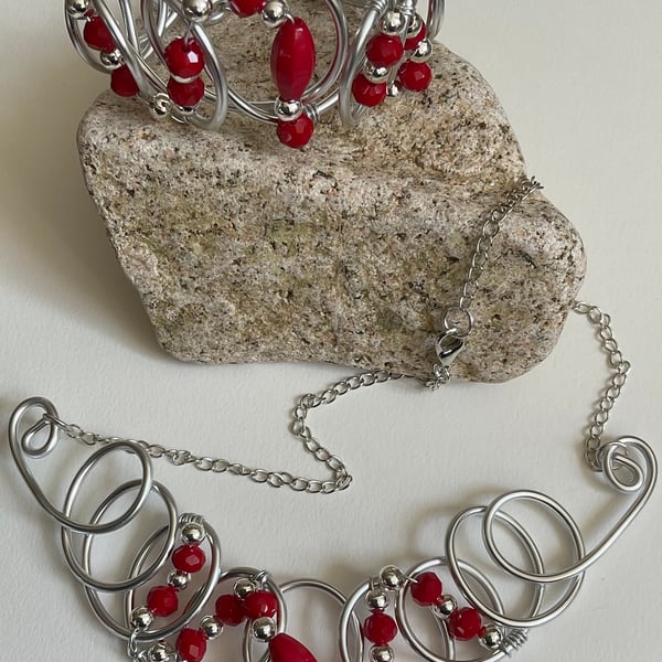 Unique red and silver coloured designer necklace with matching cuff bracelet. 